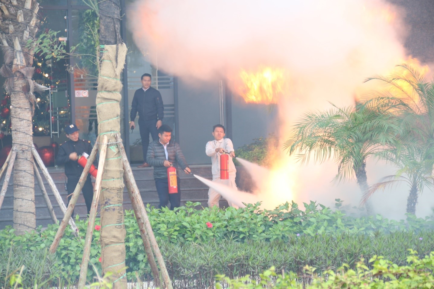 The building's firefighting force performs firefighting operations on a simulated fire on the first floor.